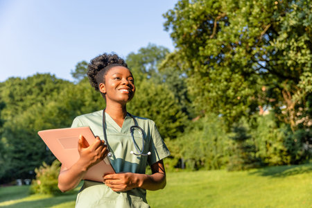 Smiling dark-skinned woman in a greenery backgroundの写真素材