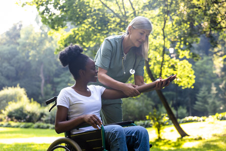 Nurse and a female on a wheelchair in the parkの写真素材