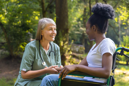 Nurse and a female on a wheelchair in the parkの写真素材