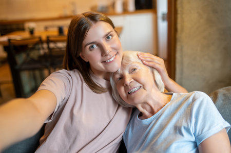 Young nurse making selfie with an elderly woman and both feeling happyの写真素材