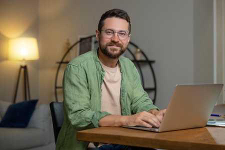Man sitting at desk working on laptopの写真素材