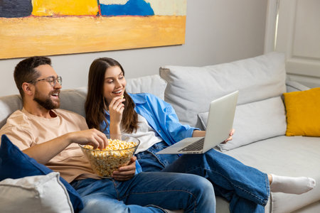 Happy couple Caucasian man and his girlfriend spending evening together at their houseの写真素材