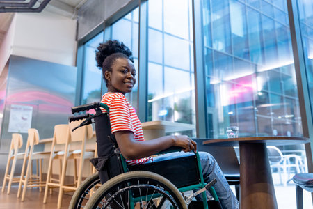 African american young woman on a wheelchair in a rehabilitation centerの写真素材