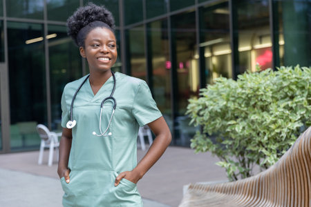 Confident african american female doctor standing in the clinics yardの写真素材