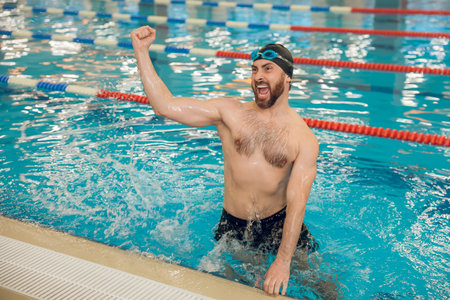 Man having a workout in the swimming pool and feeling excitedの写真素材