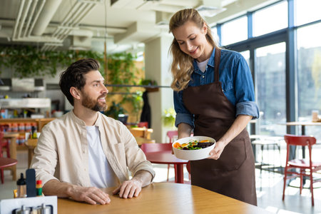 Waitress getting an order to the client in pizzeriaの写真素材