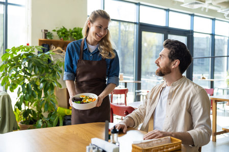 Waitress getting an order to the client in pizzeriaの写真素材