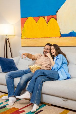 Couple watching movie together at homeの写真素材
