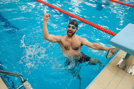 Man in swimming pool feeling excited and happyの写真素材