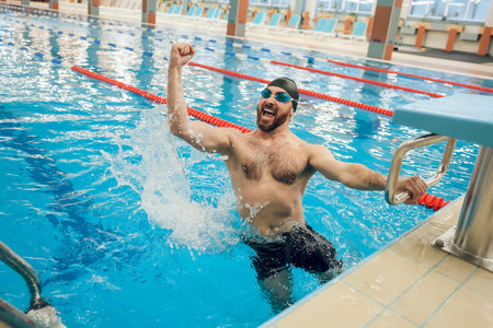 Man in swimming pool feeling excited and happyの写真素材