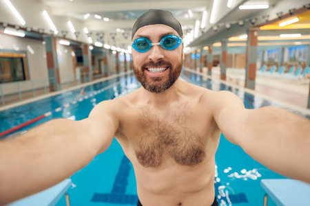 Young caucasian man making selfie in the swimming poolの写真素材