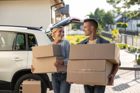 Two young people looking involved while packing for the moving to a new location
