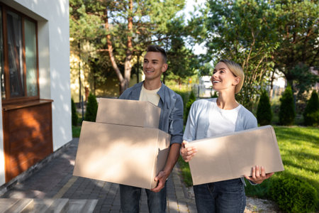 Two young people looking involved while packing for the moving to a new location