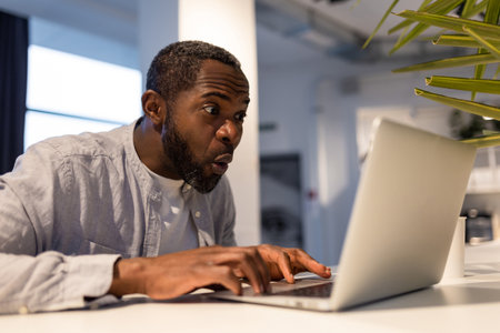 African american man at the laptop in a coworking area