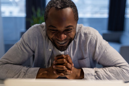 African american man having a video call and looking excitedの写真素材