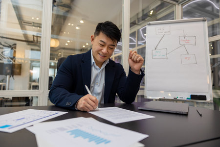 Young asian manager working on a new project and looking busyの写真素材