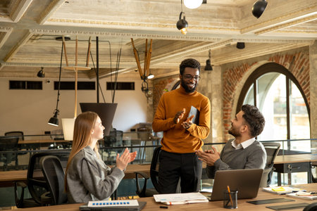 Coworkers discussing project details and looking interestedの写真素材