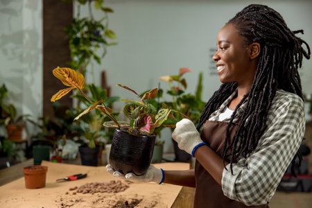 Young woman working in the flower shop and feeling goodの写真素材