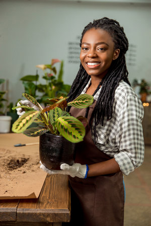 Young woman working in the flower shop and feeling goodの写真素材