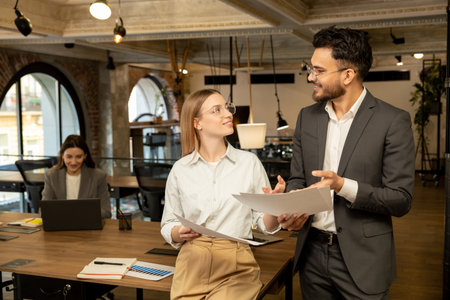 Two young professionals working in the office and looking involved