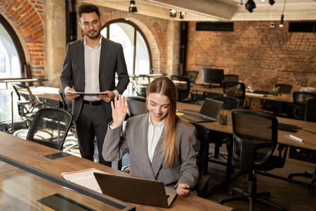 Two young professionals working in the office together