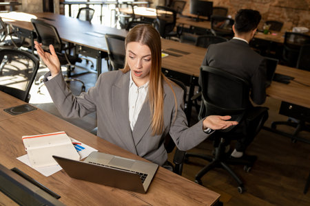 Cute long-haired blonde female manager working in the office