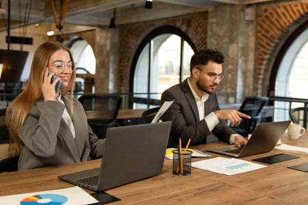 Colleagues working in the office and looking busy and involved