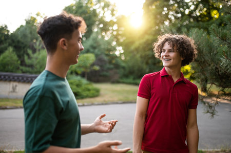 Friends spending time together in the park and looking joyfulの写真素材