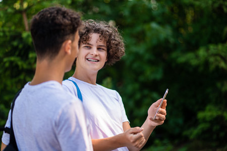 Two friends spending time outside and looking joyfulの写真素材
