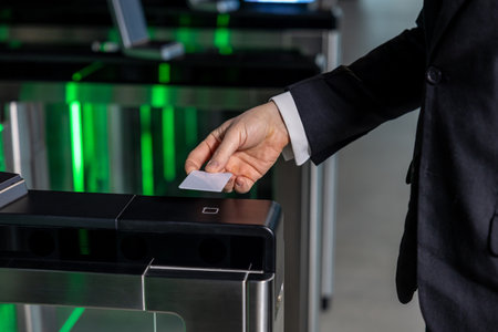 Close up of a male hand with access card on security point