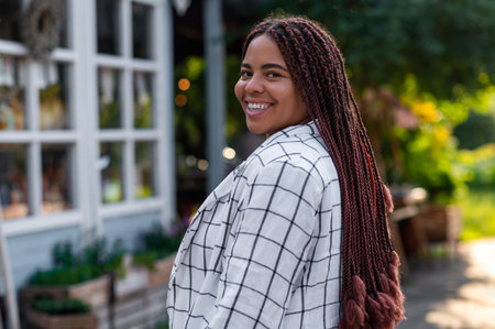 Woman wearing stylish jacket standing on street