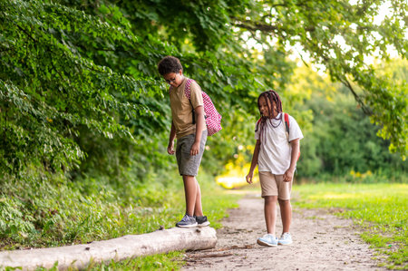 Two teens having a walk in the park after schoolの写真素材