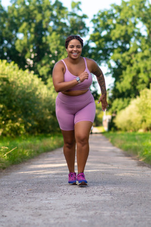 Curvy woman in activewear running fitness trainingの写真素材