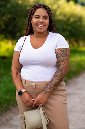 African American female enjoying leisure walk in green parkの写真素材