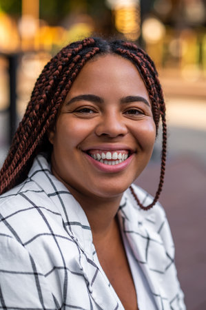 Plus size female with braids posing outdoorsの写真素材