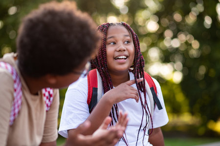 Teens sitting at the playground after school and talking