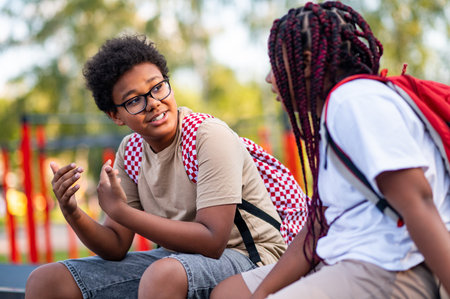 Two teens at the playground looking contented and relaxedの写真素材