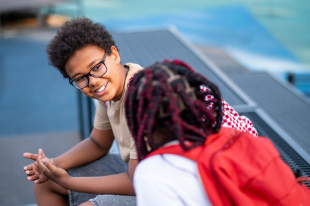 Two teens at the playground looking contented and relaxedの写真素材