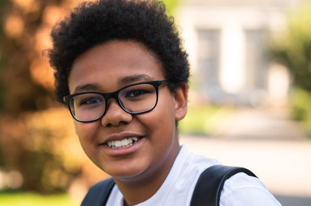 Portrait picture of a dark-skinned boy in eyeglasses
