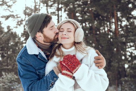 Man kissing his girl friend and both looking happy and in love