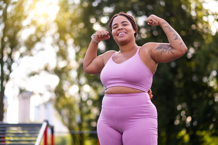 Young confident african american woman in pink looking happy