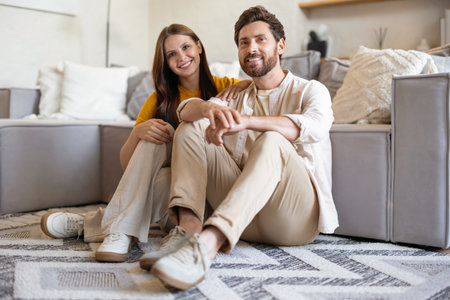 Happy couple feeling contented and peaceful spending time at homeの写真素材