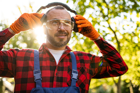 Portrait of man gardener wearing goggles and earmuffsの写真素材