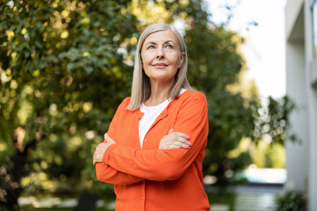 Mature blonde woman in orange shirt looking contented