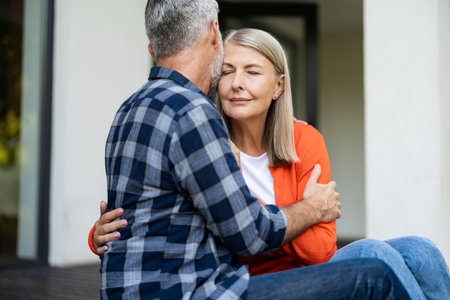 Mature couple sitting next to each other and feeling in loveの写真素材
