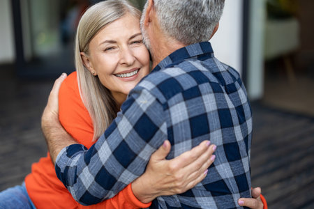 Man and woman hugging each other and looking happy and in loveの写真素材