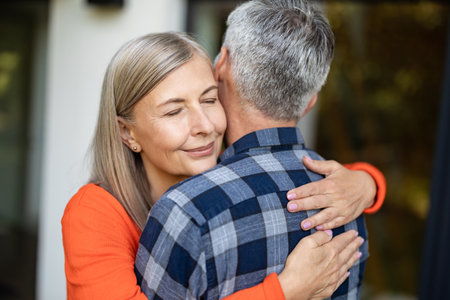 Man and woman hugging each other and looking happy and in loveの写真素材