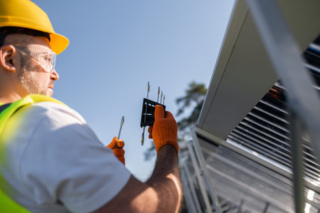 Technician working carefully on renewable energy system inspectionの写真素材