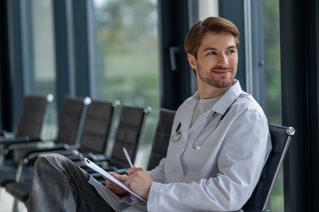 Medical professional doing paperwork in hospital interiorの写真素材