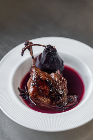 Braised lamb shank or duck leg with sauce and topinambur chips garnishの写真素材